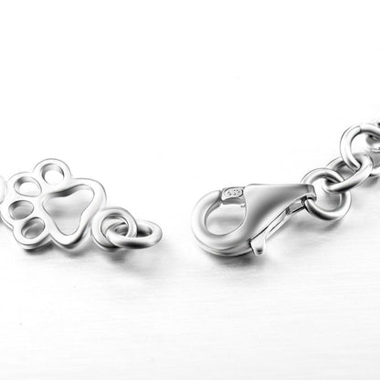 Armband met hondenpoot- en botbedels in zilver