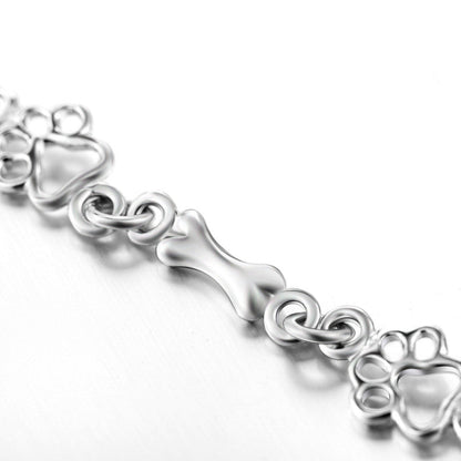 Armband met hondenpoot- en botbedels in zilver