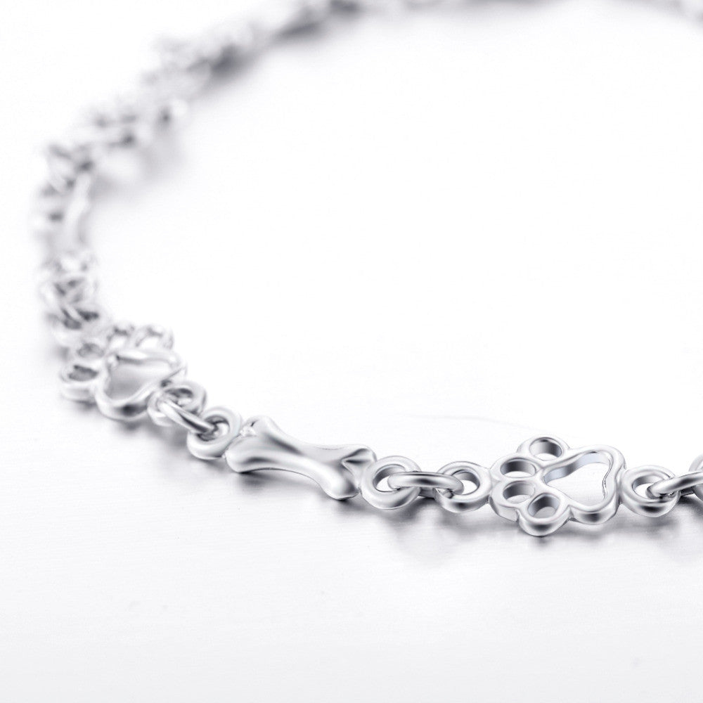 Armband met hondenpoot- en botbedels in zilver